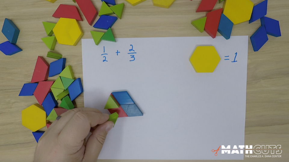 image of hand manipulating math blocks